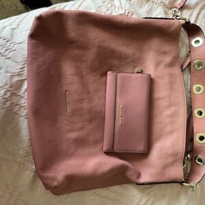 Michael Kors Handbag with matching wallet in a pink leather color.